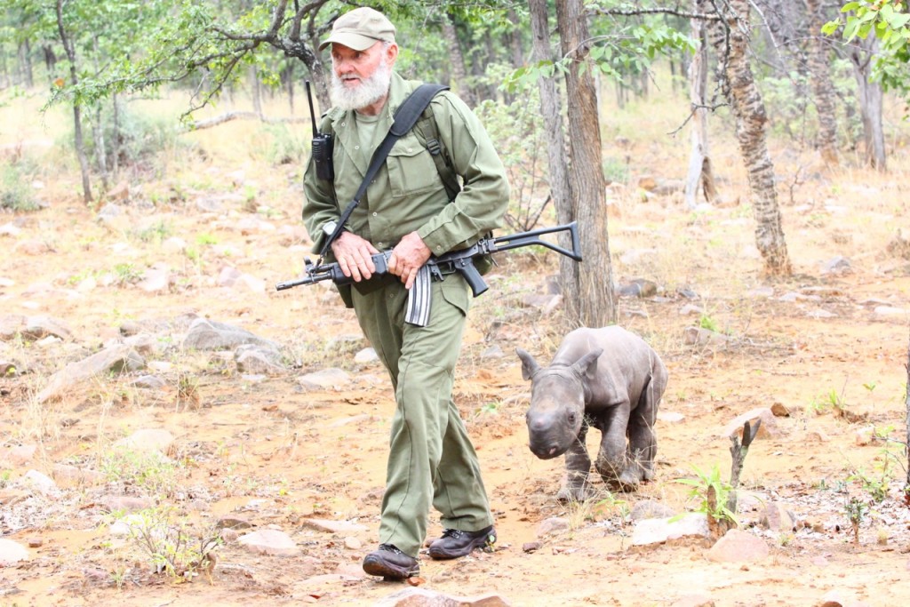 Bryce's father, Pete Clemence, with a baby rhino saved after its mother was poached last year in Save Valley Conservancy, Zimbabwe.  The calf is now being rehabilitated at a nearby conservancy for eventual return to the wild.