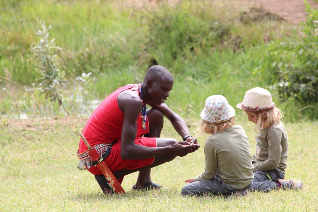Maasai guide Sam sharing his knowledge with 7 year old twins, Lucie & Bella, at the Mara Bush Houses